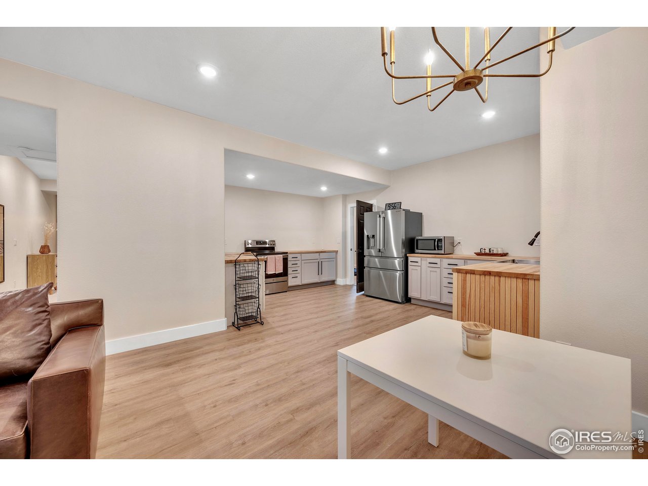 3058 West 111th Drive Westminster, CO 80031 - Photo 24 of 39 a living room with stainless steel appliances kitchen island a table and chairs