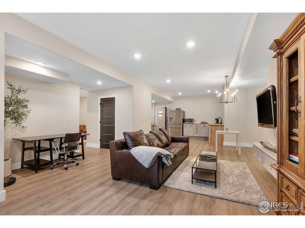 3058 West 111th Drive Westminster, CO 80031 - Photo 27 of 39 a living room with furniture wooden floor and a flat screen tv