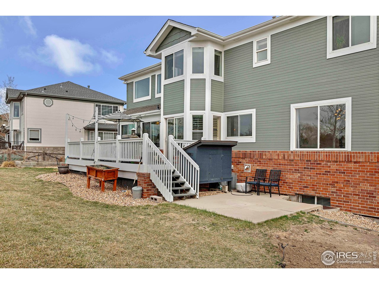 3058 West 111th Drive Westminster, CO 80031 - Photo 33 of 39 a backyard of a house with fire pit and chairs