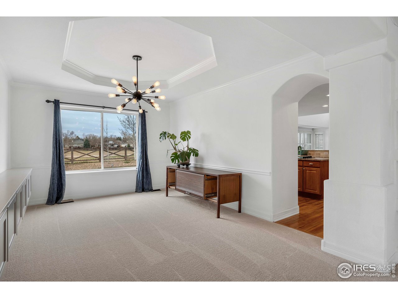 3058 West 111th Drive Westminster, CO 80031 - Photo 7 of 39 a living room with furniture and a chandelier