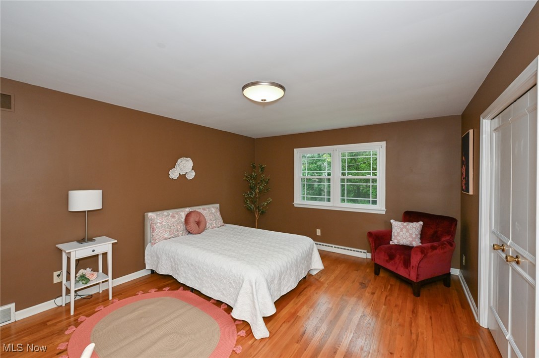 2015 Burlington Road Akron, OH 44313 - Photo 20 of 50 Bedroom featuring a baseboard radiator, wood finished floors, and baseboards