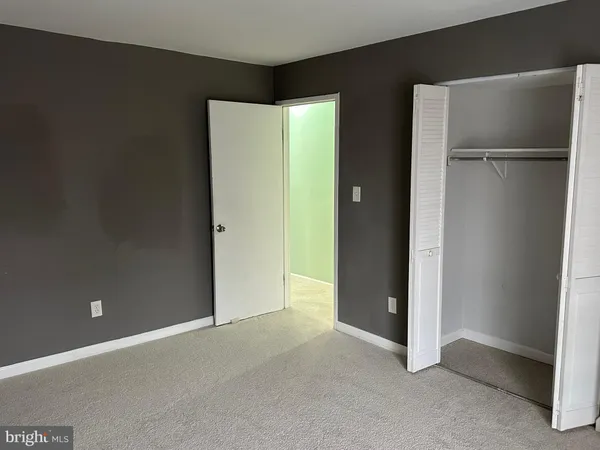 a view of an empty room with closet area