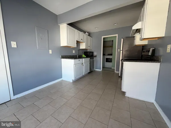 a kitchen with stainless steel appliances granite countertop a refrigerator sink and cabinets