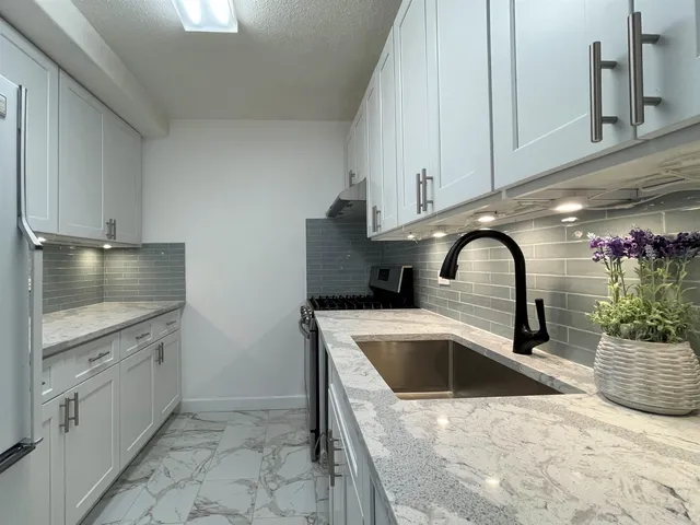 a kitchen with a sink and cabinets