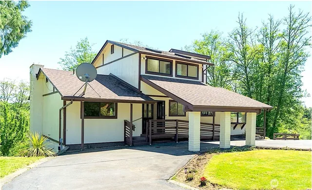 a front view of a house with a yard porch and livingroom