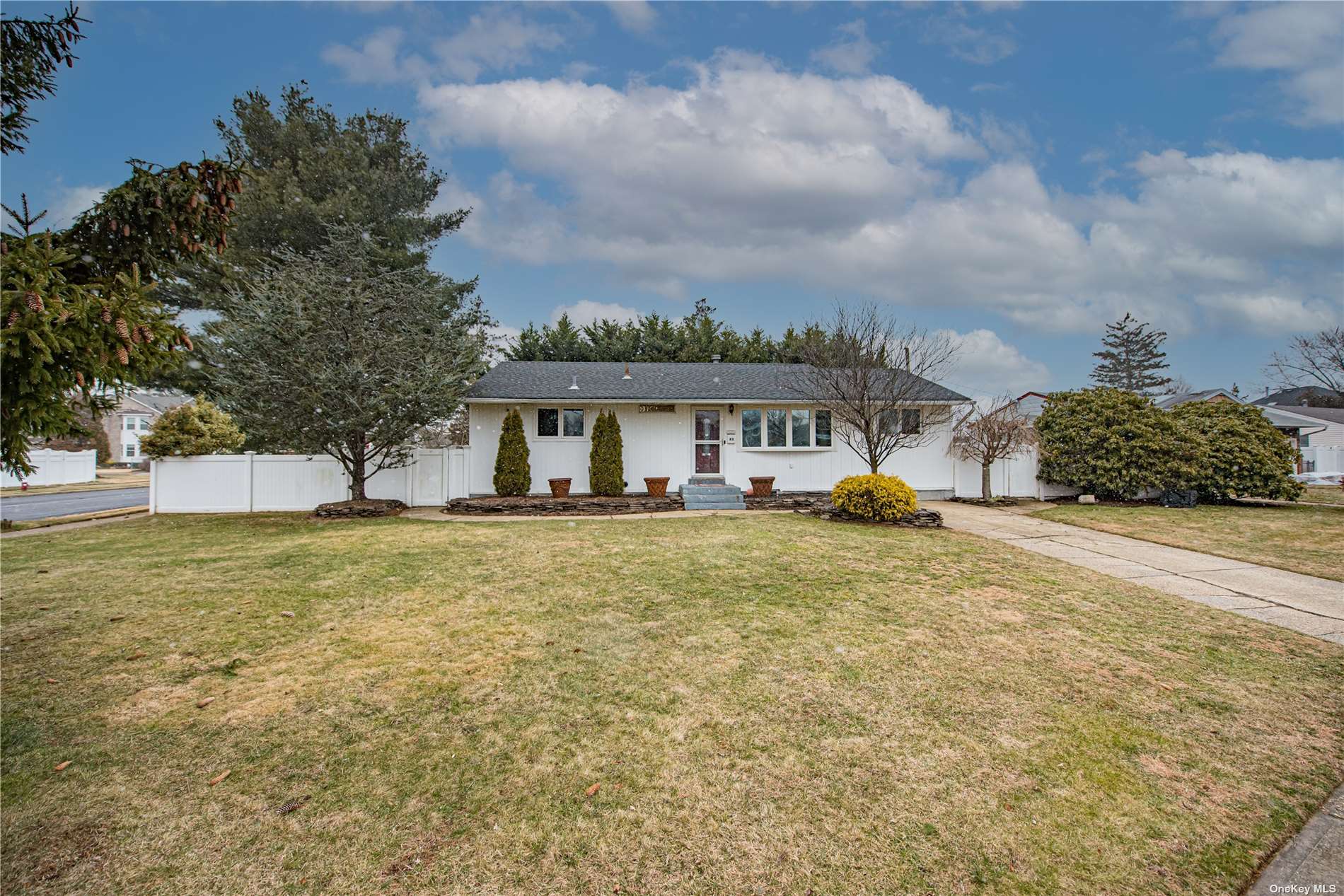 a front view of a house with a garden