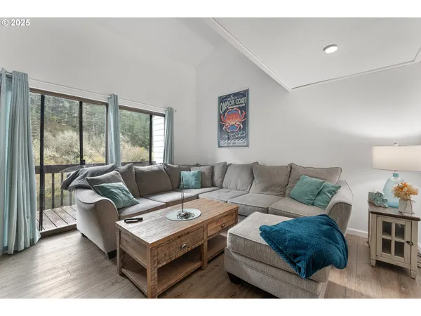 a living room with furniture and a floor to ceiling window