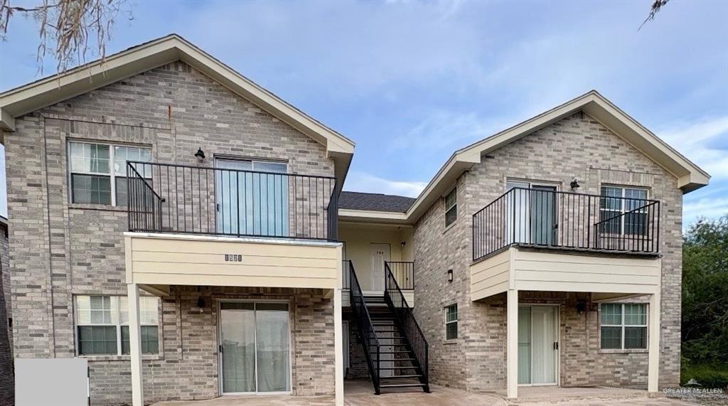 a view of small house with large windows