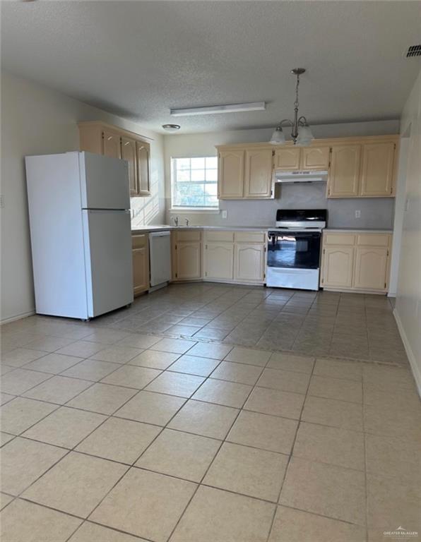 1521 Oasis Drive Mission, TX 78572 - Photo 14 of 18 a kitchen with stainless steel appliances granite countertop a refrigerator and a sink