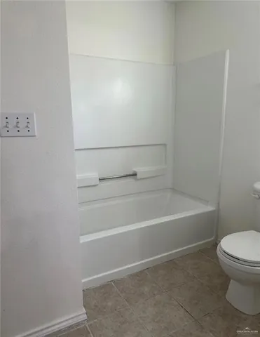 a bathroom with a toilet and a bathtub