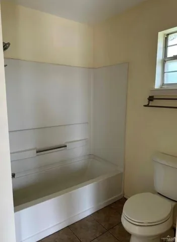 a bathroom with a shower and a toilet