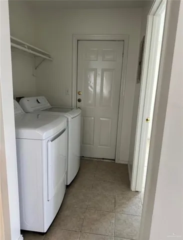 a utility room with cabinets washer and dryer