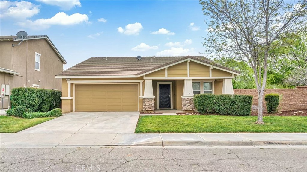 1371 Bouvardia Place Beaumont, CA 92223 - Photo 1 of 1 a front view of a house with a yard and garage