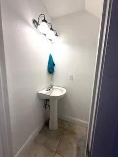 a bathroom with a sink and mirror