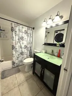 a bathroom with a sink mirror and toilet