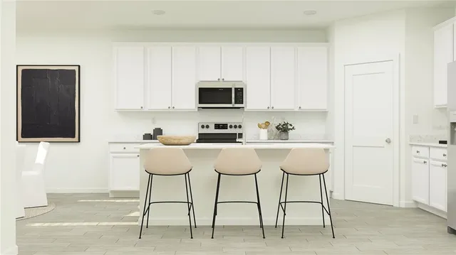 a kitchen with stainless steel appliances kitchen island granite countertop a sink and cabinets