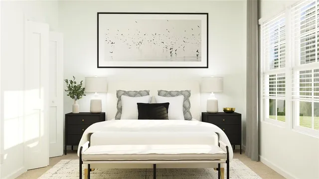 a bedroom with a bed and a painting on the wall