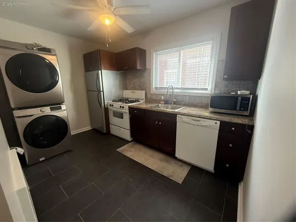 a kitchen with a sink a stove and cabinets