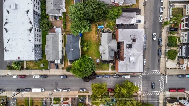 an aerial view of a house with table and chairs and potted plants