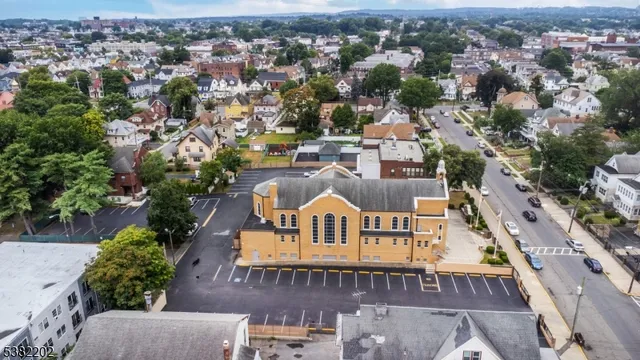 an aerial view of residential house with yard and swimming pool
