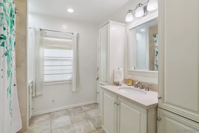 a bathroom with a sink vanity and a mirror