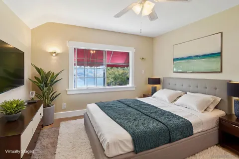 a bedroom with a large bed and a potted plant