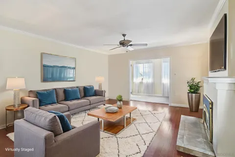 a living room with furniture a chandelier and a window
