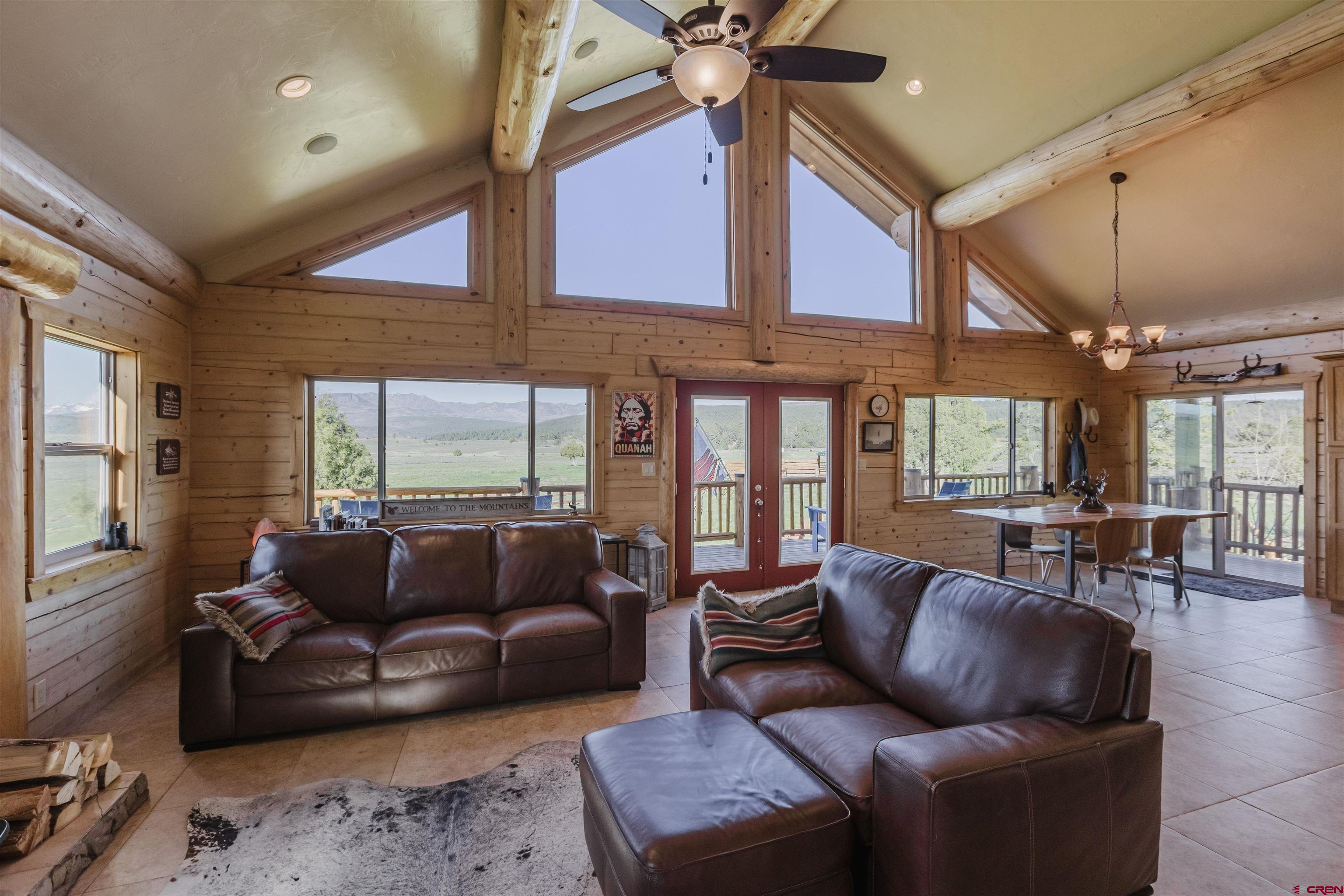 2439 County Road 359 Pagosa Springs, CO 81147 - Photo 16 of 45 a living room with furniture ceiling fan and a window