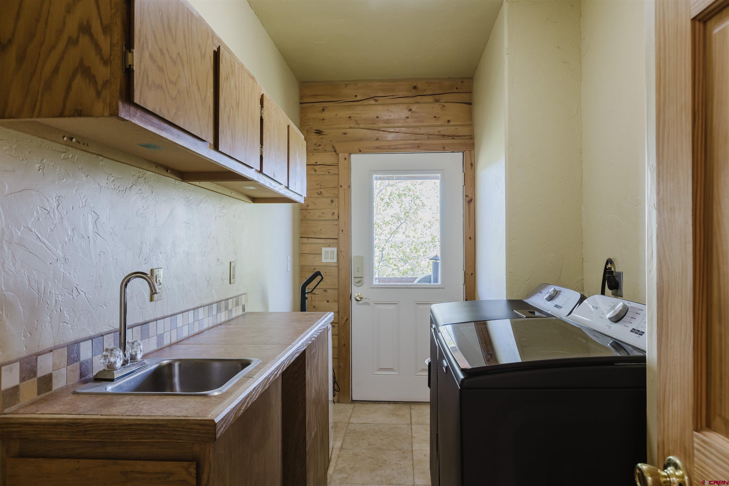 2439 County Road 359 Pagosa Springs, CO 81147 - Photo 20 of 45 a kitchen with a sink and cabinets