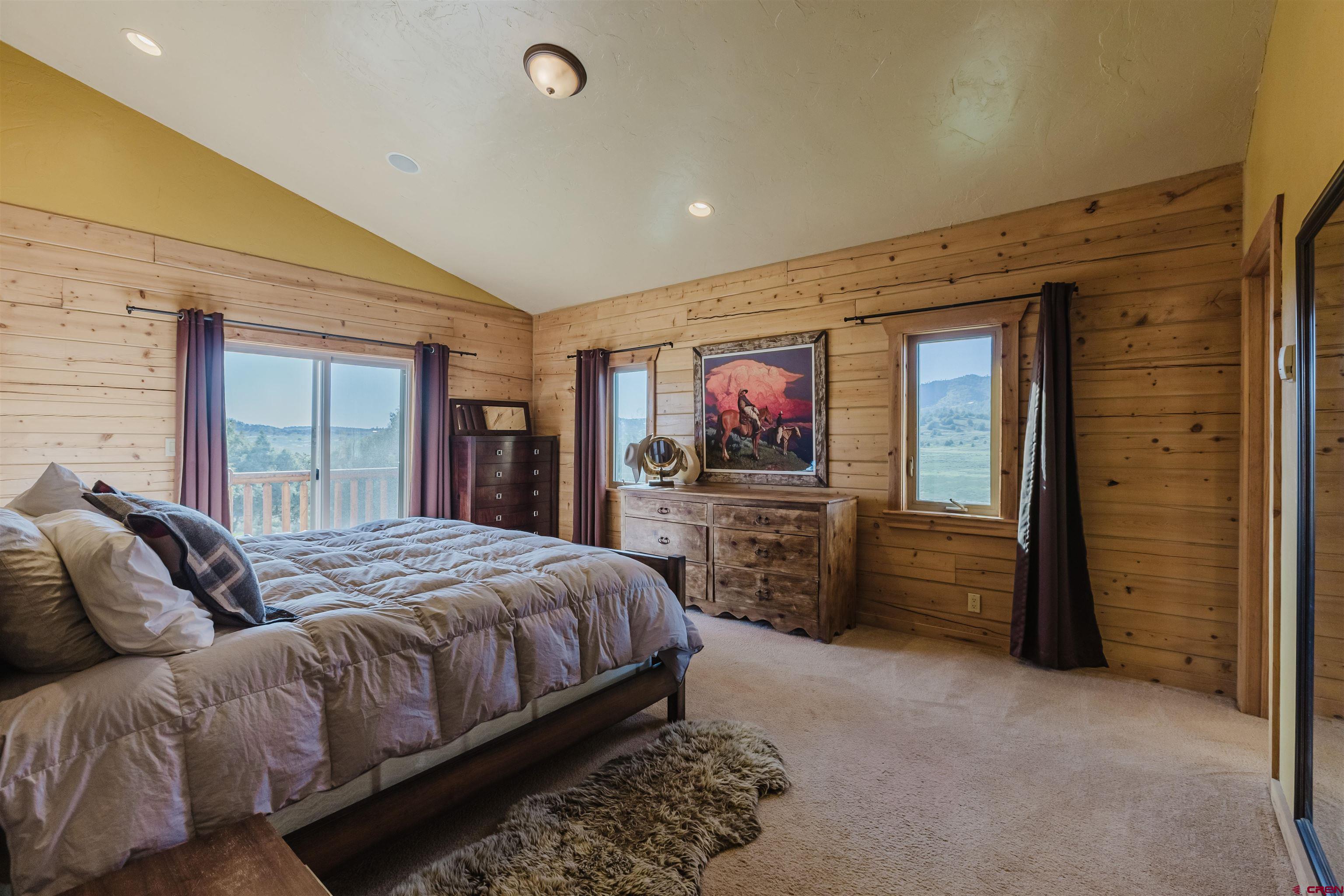2439 County Road 359 Pagosa Springs, CO 81147 - Photo 22 of 45 a bedroom with a bed and a flat screen tv