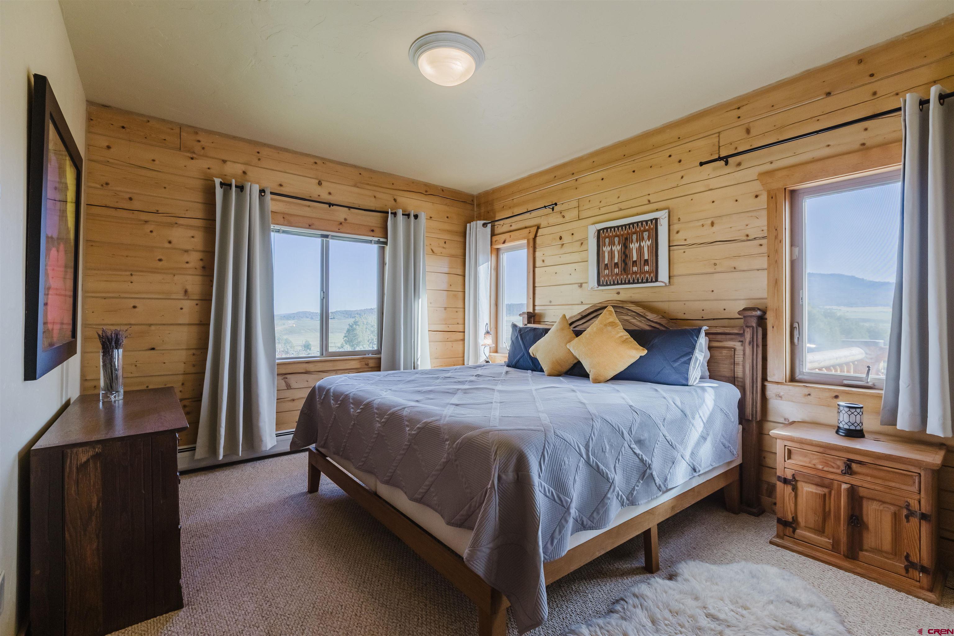 2439 County Road 359 Pagosa Springs, CO 81147 - Photo 29 of 45 a bedroom with a bed and wooden floor