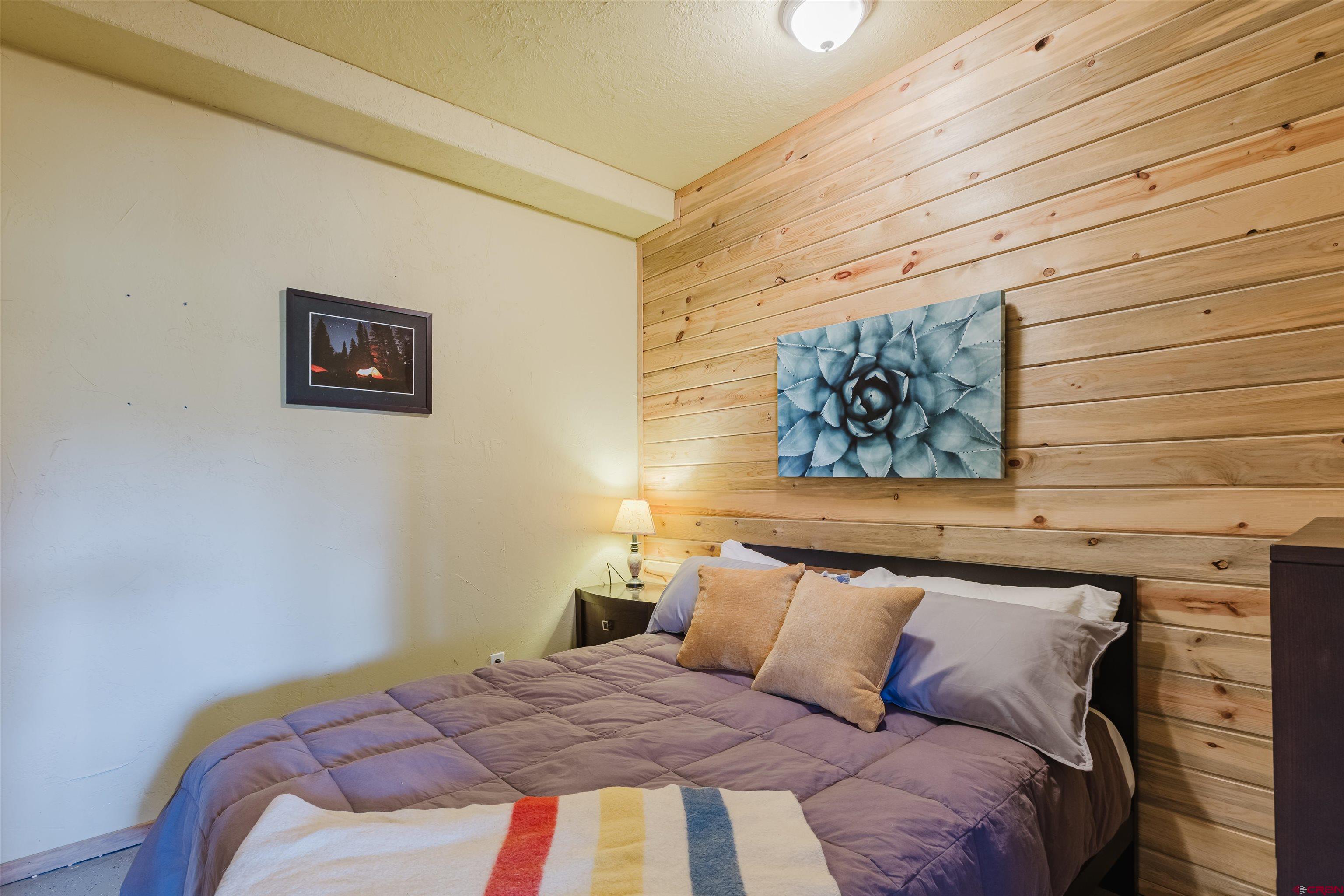 2439 County Road 359 Pagosa Springs, CO 81147 - Photo 32 of 45 a bedroom with a bed and a wall painting