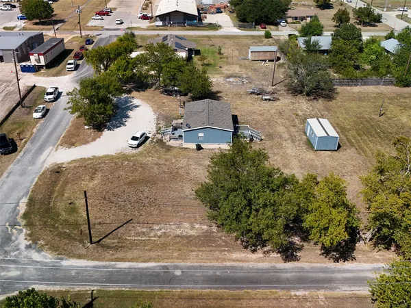 an aerial view of a house with yard and lake view