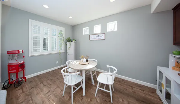 a view of a dining room with furniture and a window