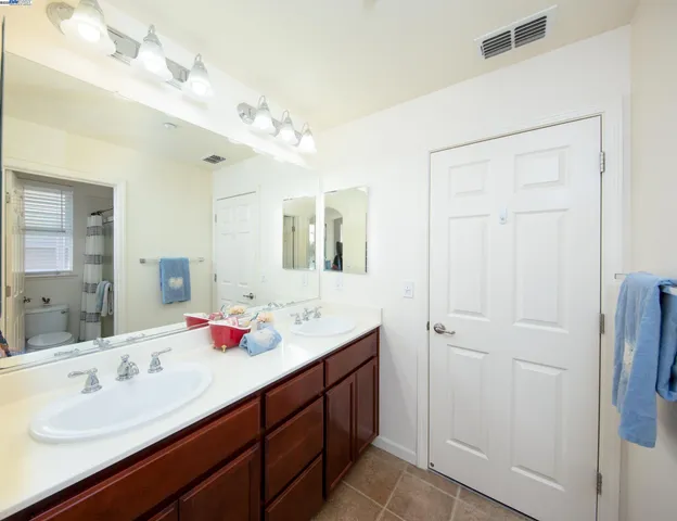 a bathroom with a double vanity sink mirror and double