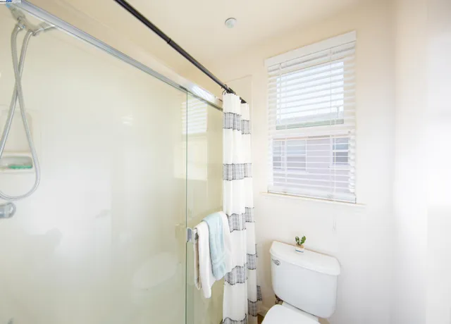 a bathroom with a toilet a sink and a shower