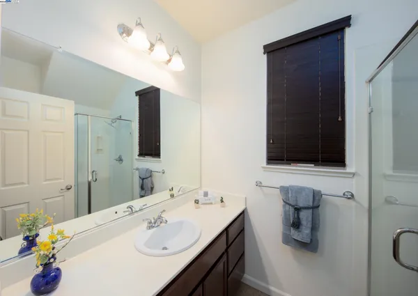 a bathroom with a sink double vanity and a mirror