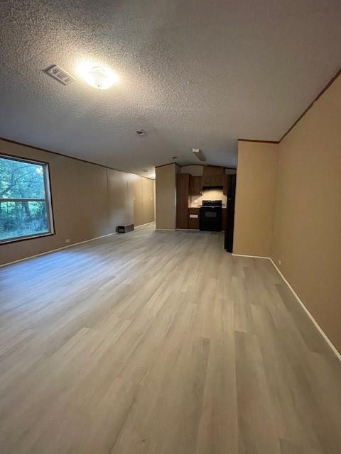 3125 Bois D Arc Road Combine, TX 75159 - Photo 3 of 15 Unfurnished living room featuring light wood-type flooring and a textured ceiling