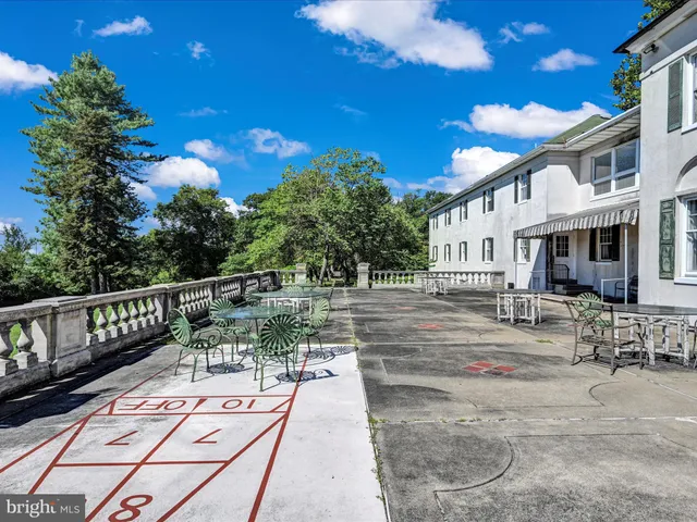 a kitchen with stainless steel appliances kitchen island granite countertop a refrigerator and a sink