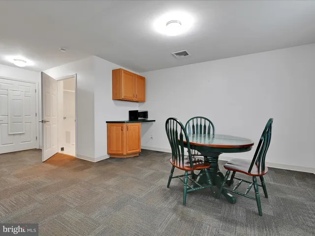an aerial view of a houses with outdoor space and trees all around