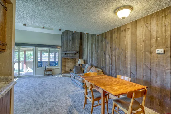 a room with pool table and windows