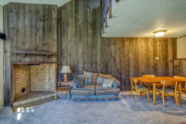 a living room with furniture a rug and a fireplace