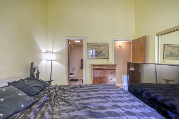 a bedroom with a bed and a dresser