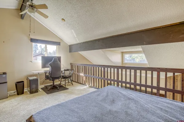 a view of a livingroom with furniture and a window