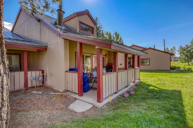 a view of a house with backyard and porch