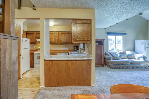 a living room with kitchen island granite countertop furniture and fireplace