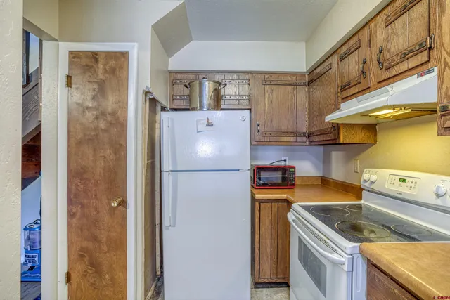 a kitchen with a refrigerator and a stove