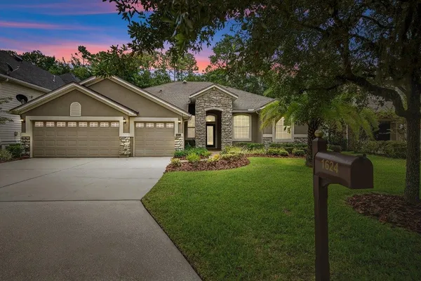 a front view of a house with a garden
