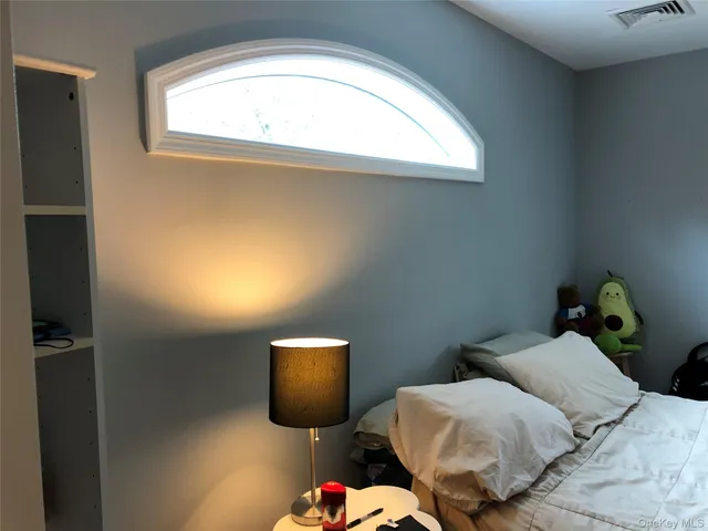 a bedroom with bed and a window