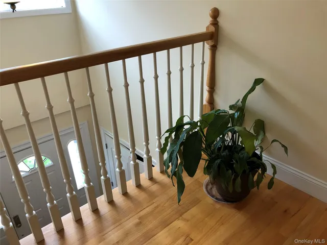 a vase of flowers sitting on a table with wooden floor